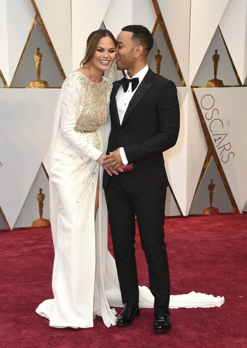 Chrissy Teigen, left, and John Legend arrive at the Oscars on Sunday, Feb. 26, 2017, at the Dolby Theatre in Los Angeles. (Photo by Jordan Strauss/Invision/AP)