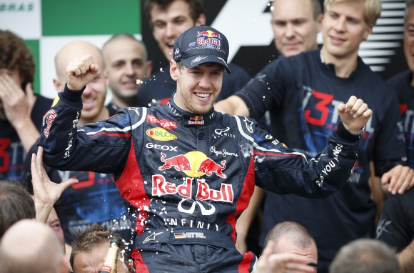 Nemecký pretekár Sebastian Vettel oslavuje s členmi svojho tímu Red Bull zisk titulu majstra sveta a zároveň Pohára konštruktérov.