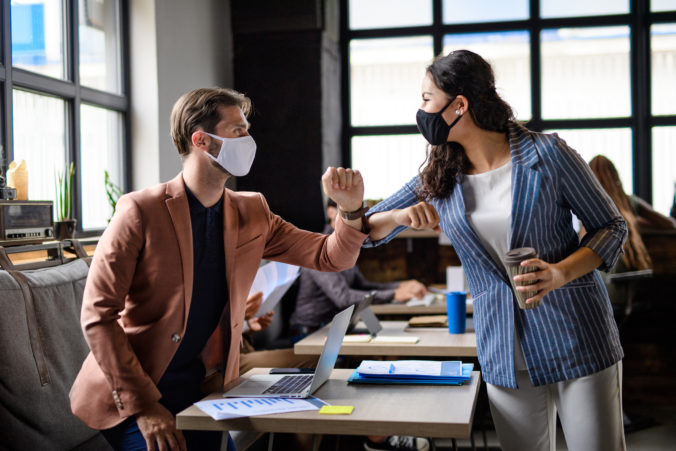 business people with face masks greeting indoors i rmdemtr_edit 676x451